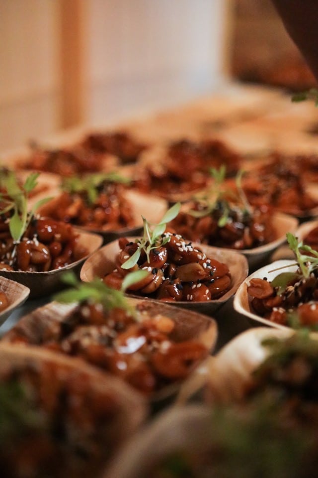 Tray of braised beef canapés garnished with microgreens